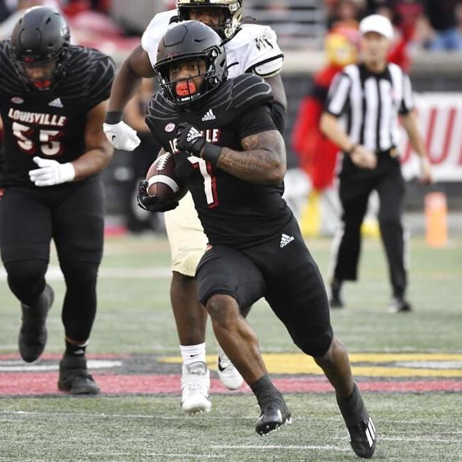 Louisville running back Tiyon Evans runs from the Wake Forest defense.jpeg